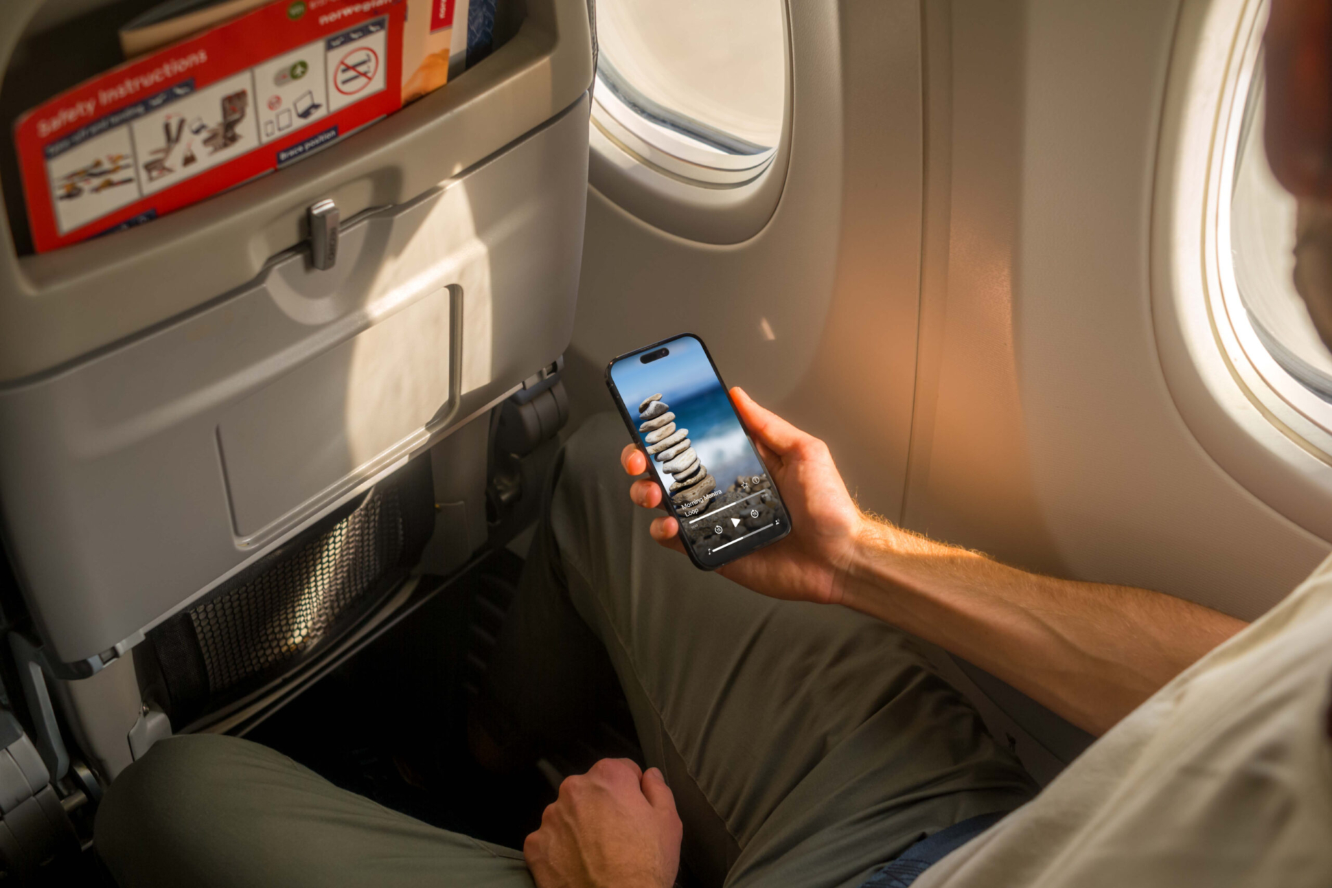 Mockuuups Free iPhone 14 Pro on a Plane Mockup
