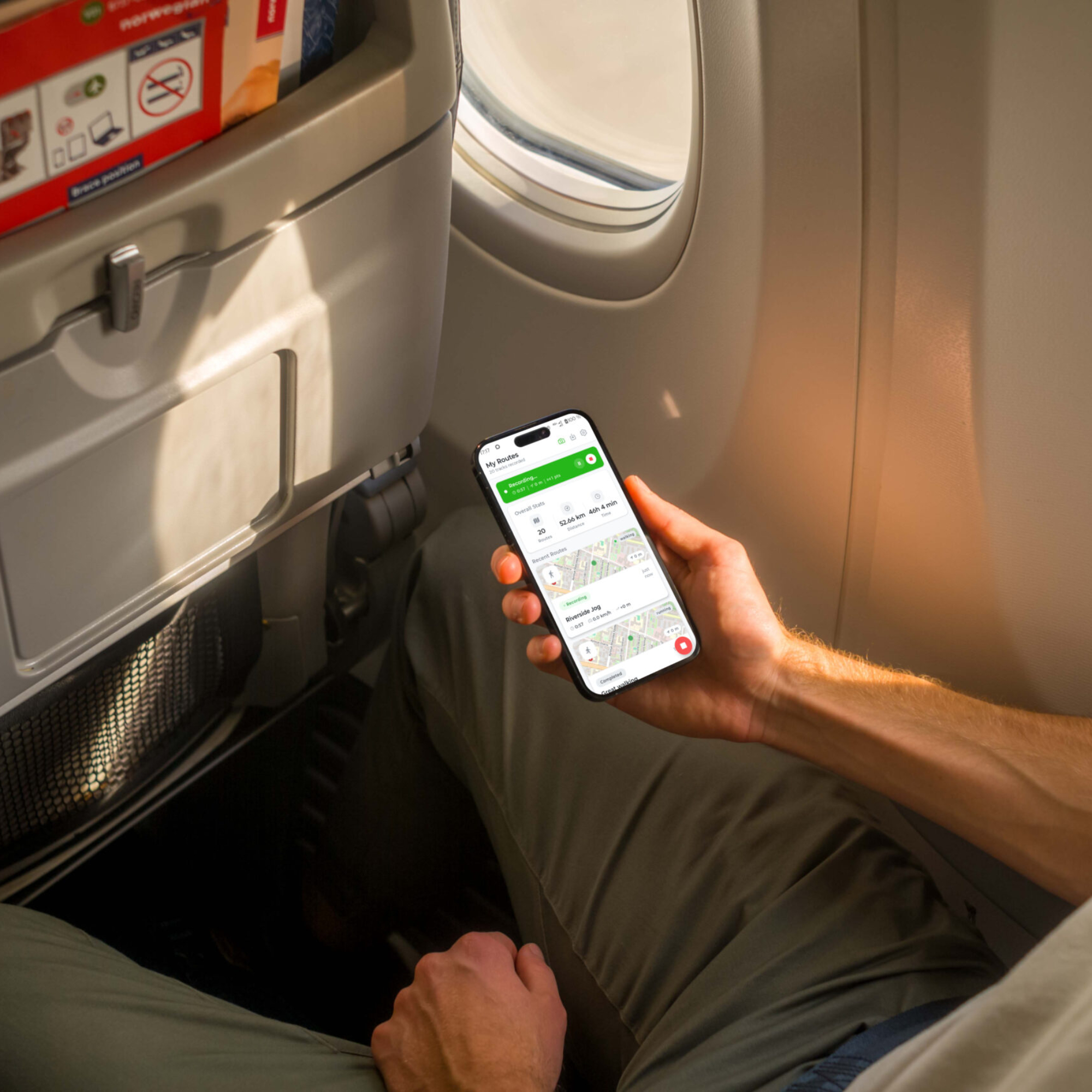 Mockuuups Free iPhone 14 Pro on a Plane Mockup